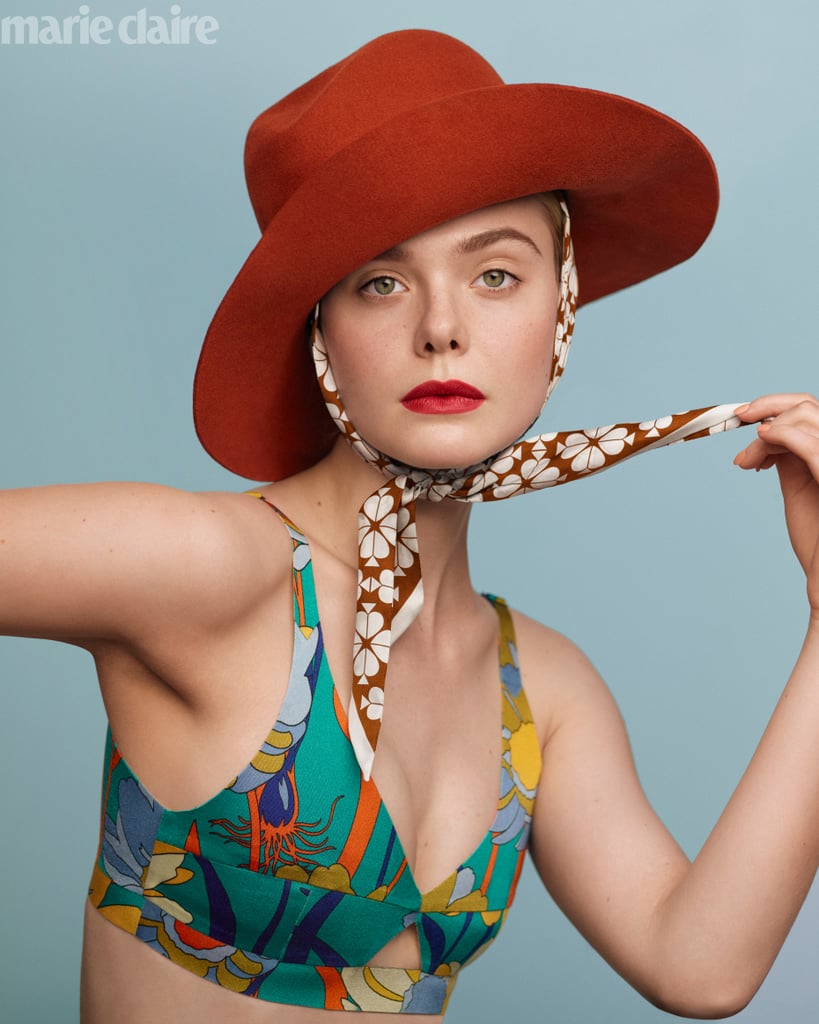 Elle fanning wearing a Fendi top, Janessa Leoné hat, and Kate Spade scarf.