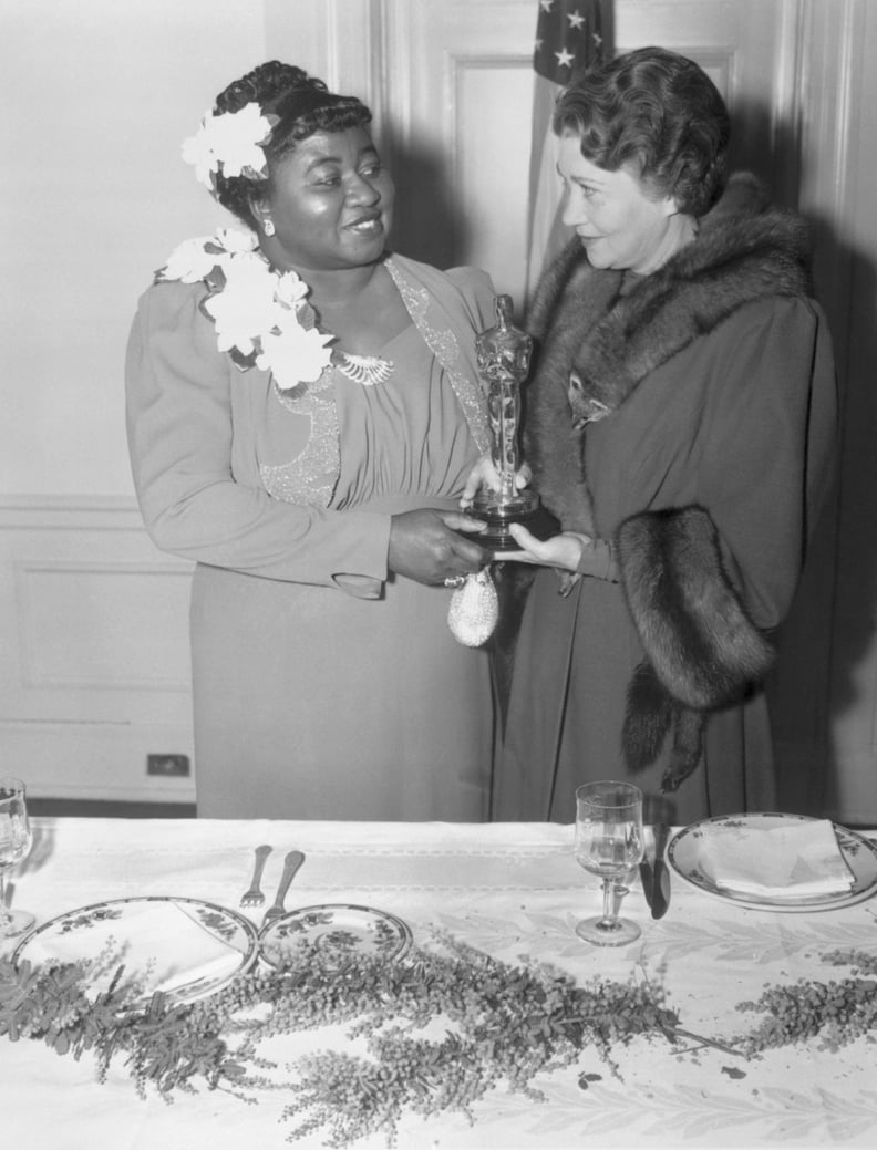 (Original Caption) Twelfth Annual Banquet of the Academy of Motion Picture Arts and Sciences. Los Angeles, California: Actress Fay Bainter (right) presenting Hattie McDaniel (left) her award for her supporting role in Gone With the Wind. February 29, 1940