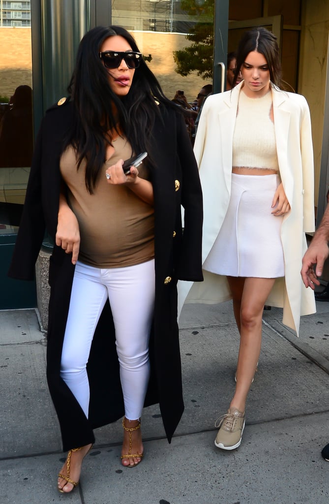 Kim and Kendall were totally in step as they headed out to the US Open, balancing their coats on their shoulders.