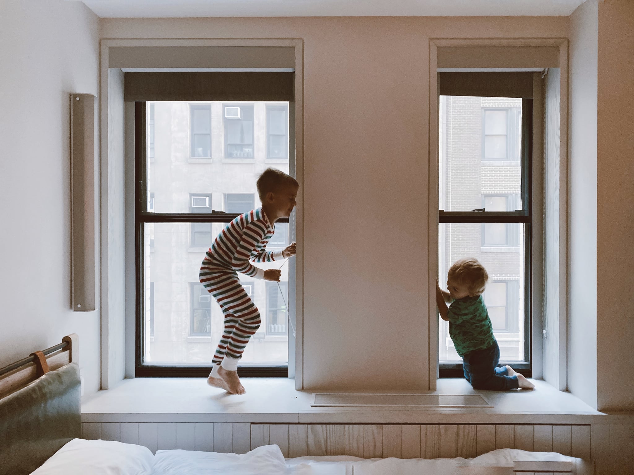 tmp_mBeS9g_2777e8187628ed1a_two-kids-playing-beside-glass-windows-3273851.jpg