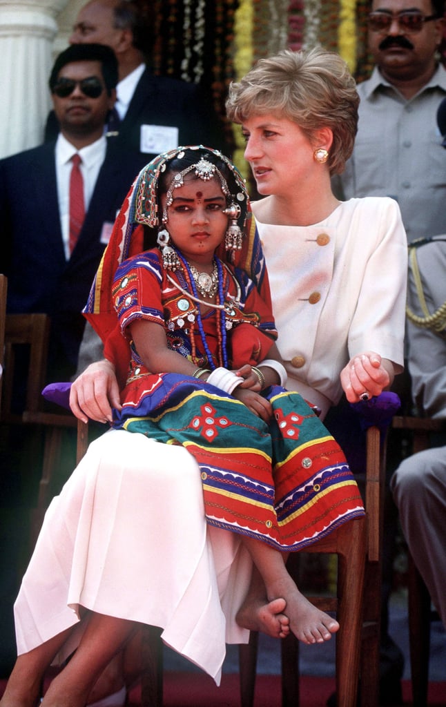 She let a local girl sit on her lap during her visit to Lallapet High School in Hyderabad, India, in February 1992.