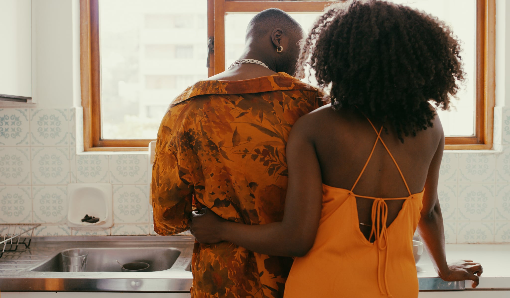 Shot of a young couple sharing a romantic moment while washing the dishes at home