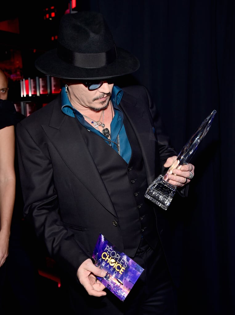 Johnny Depp checked out his award for favorite movie actor.