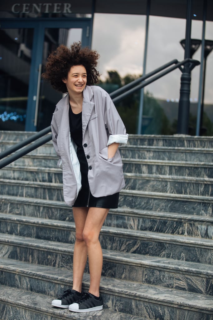 An oversize blazer and sneakers read smart yet casual over a miniskirt.