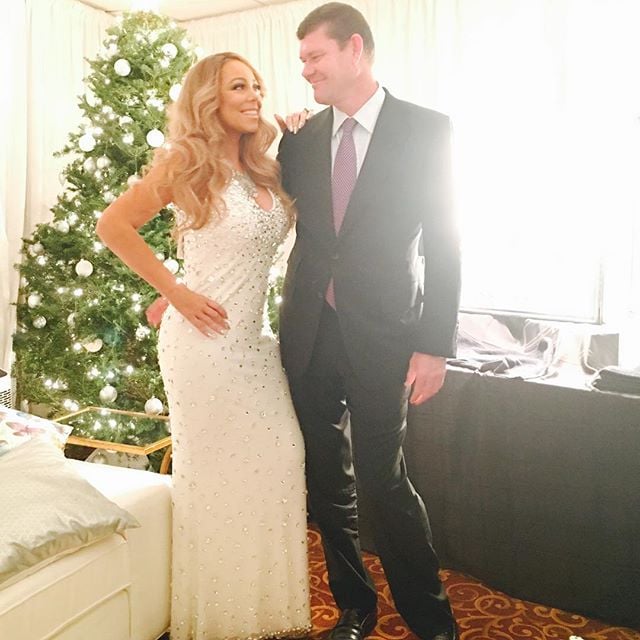 Mariah Carey and her boyfriend, James Packer, posed for a romantic photo in front of a Christmas tree.
