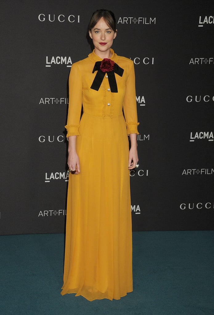 Dakota Johnson in a long-sleeved, mustard-colored Gucci gown at the LACMA 2015 Art+Film Gala.