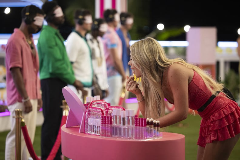 Liv Walker applying lip gloss on Love Island USA
