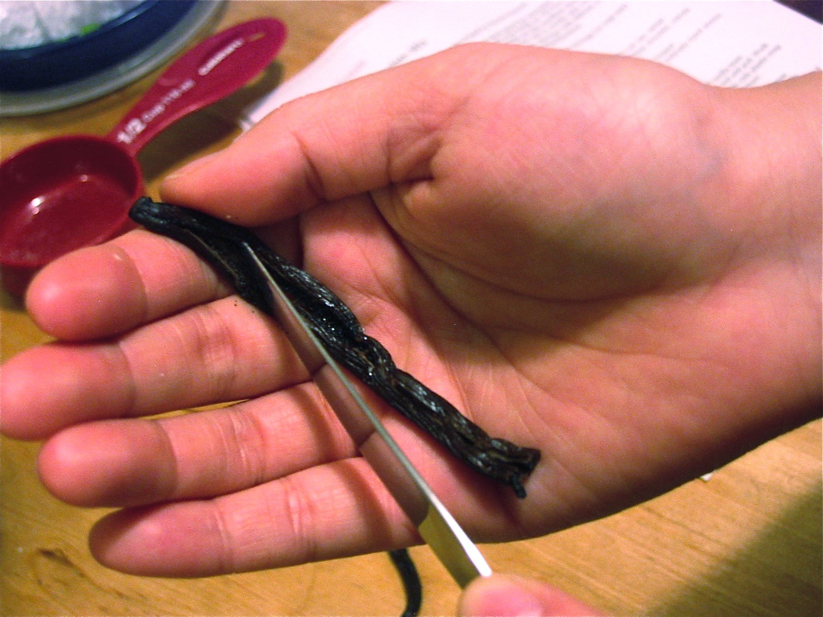 After splitting vanilla bean crosswise, scrape seeds out and add to sugar. 