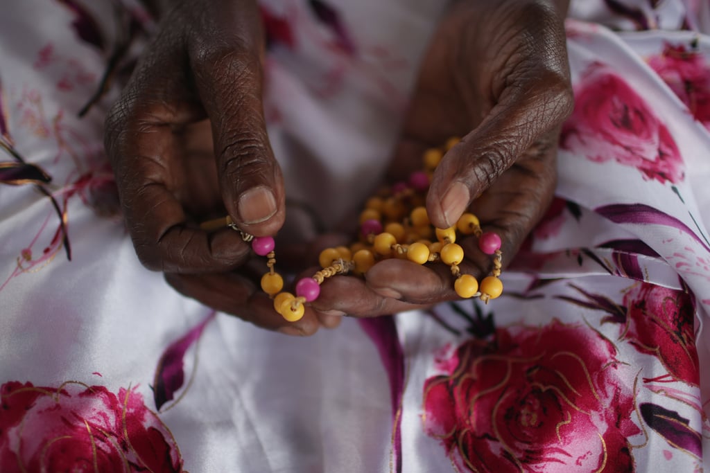 Ophelia Nyiramgumeri held a rosary that belonged to her nephew, who was murdered in the genocide, in her Kigali home on Saturday.