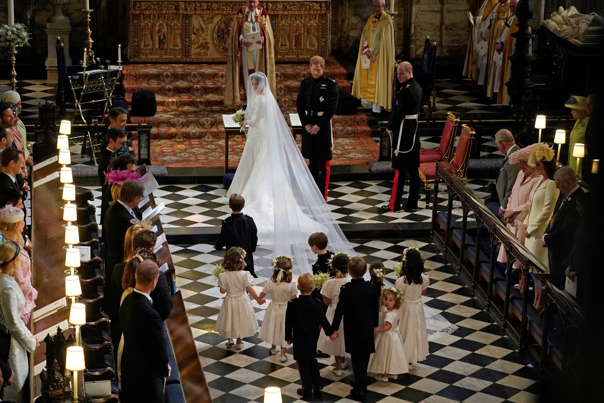 Britain's Prince Harry, Duke of Sussex (centre R) and US actress Meghan Markle (centre) stand at the altar with their bridsesmaids and page boys in St George's Chapel, Windsor Castle, in Windsor, on May 19, 2018 during their wedding ceremony with best man Britain's Prince William, Duke of Cambridge, (R) standing to the side. (Photo by Owen Humphreys / POOL / AFP)        (Photo credit should read OWEN HUMPHREYS/AFP/Getty Images)