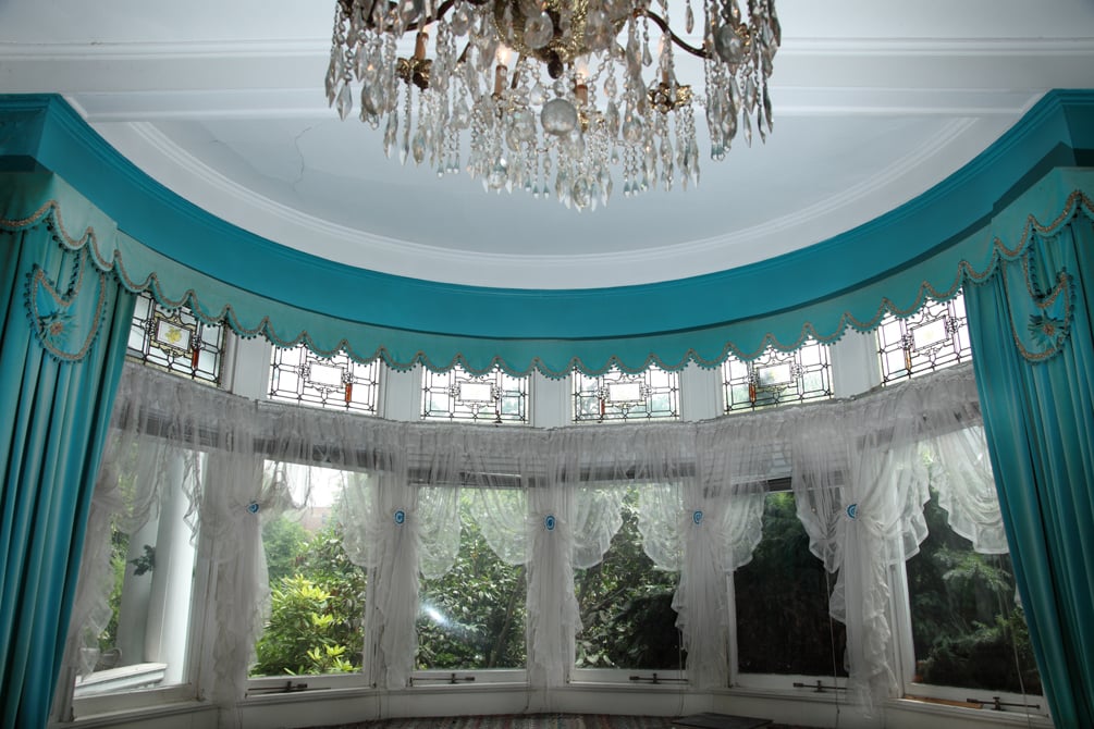 It looks a bit like a Southern ballroom right now, but this room's rounded windows and high ceilings will make for a great entertaining space.