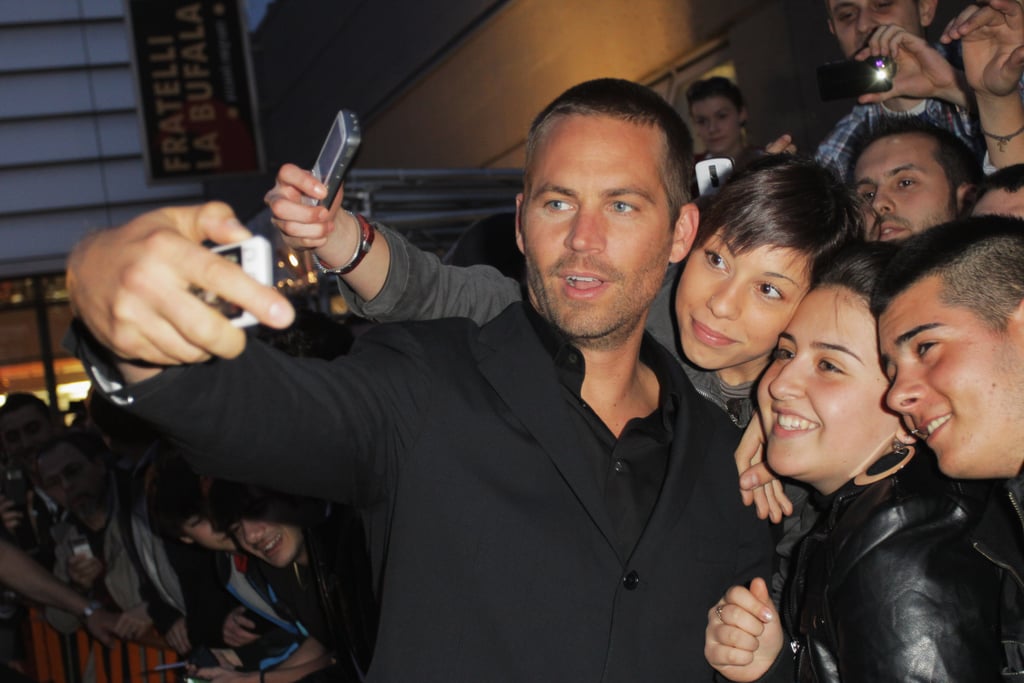 He snapped photos with a group of fans during the Fast Five premiere in Rome, Italy, in April 2011.