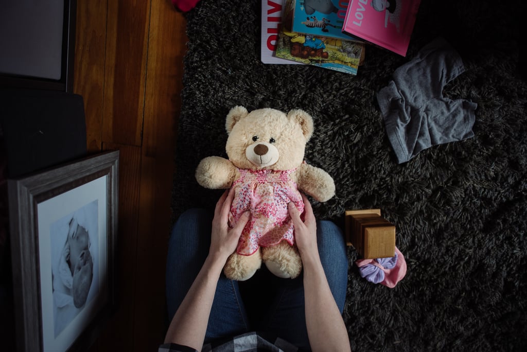 "Kristin holds her Molly Bear in Abby's nursery. Molly Bears is a nonprofit organization that creates weighted teddy bears, the approximate weight of the deceased infant, for families coping with infant loss."