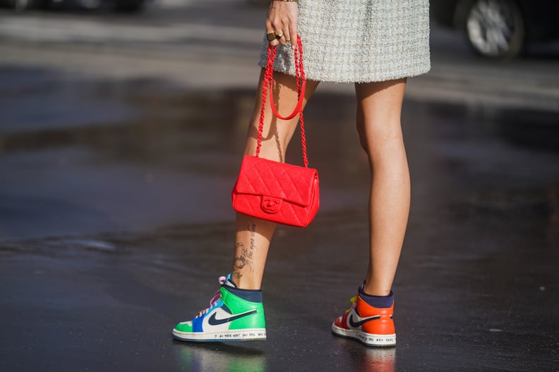 PARIS, FRANCE - MARCH 03: A guest wears a red quilted Chanel bag, Nike colored sneakers shoes, outside Chanel, during Paris Fashion Week - Womenswear Fall/Winter 2020/2021 on March 03, 2020 in Paris, France. (Photo by Edward Berthelot/Getty Images)