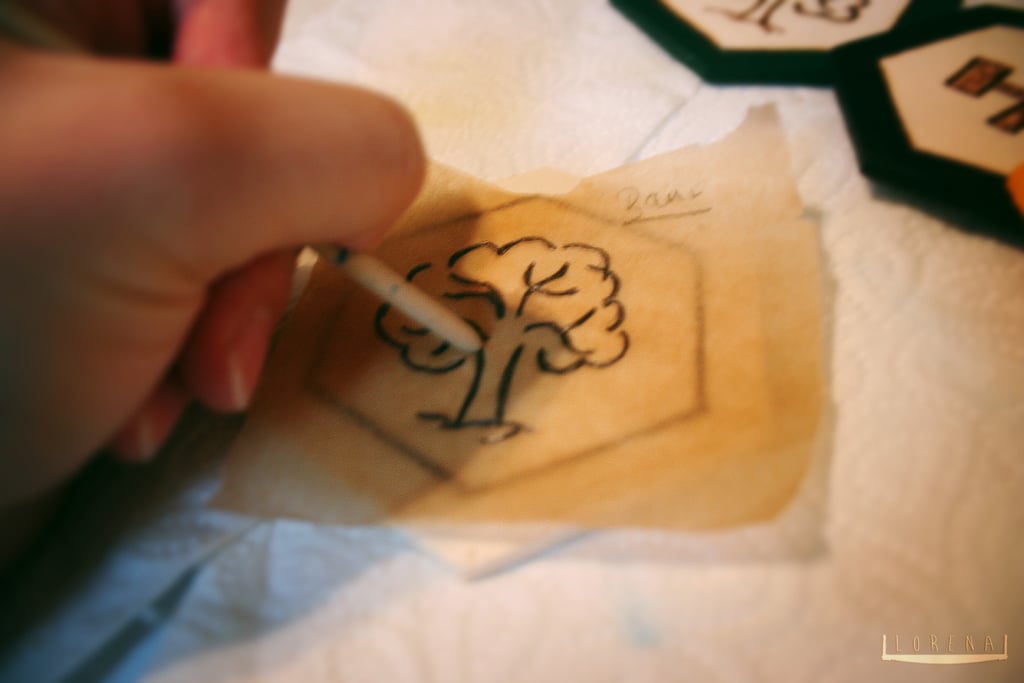 "Using the end of a paintbrush the tracing is rubbed into the wood."