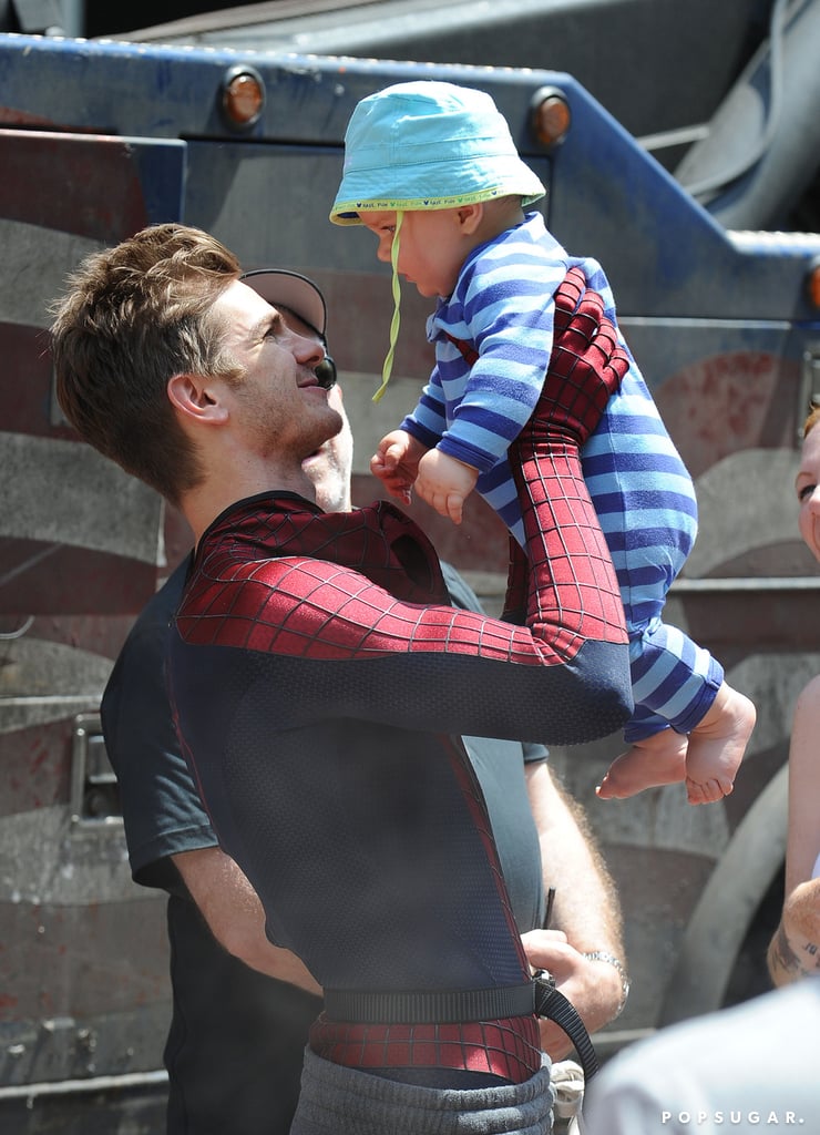 Andrew had fun with a baby between takes on the Amazing Spider-Man 2 set in NYC back in July 2013.