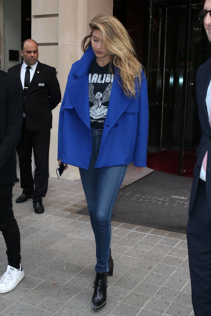 Gigi added another casual ensemble to her list of flawless street style looks — she tucked a graphic tee into skinny jeans and pointed-toe boots and finished with a luxe blue coat.