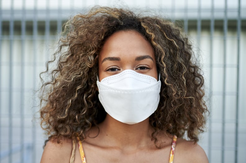 Woman wearing surgical mask, preventing against COVID-19.