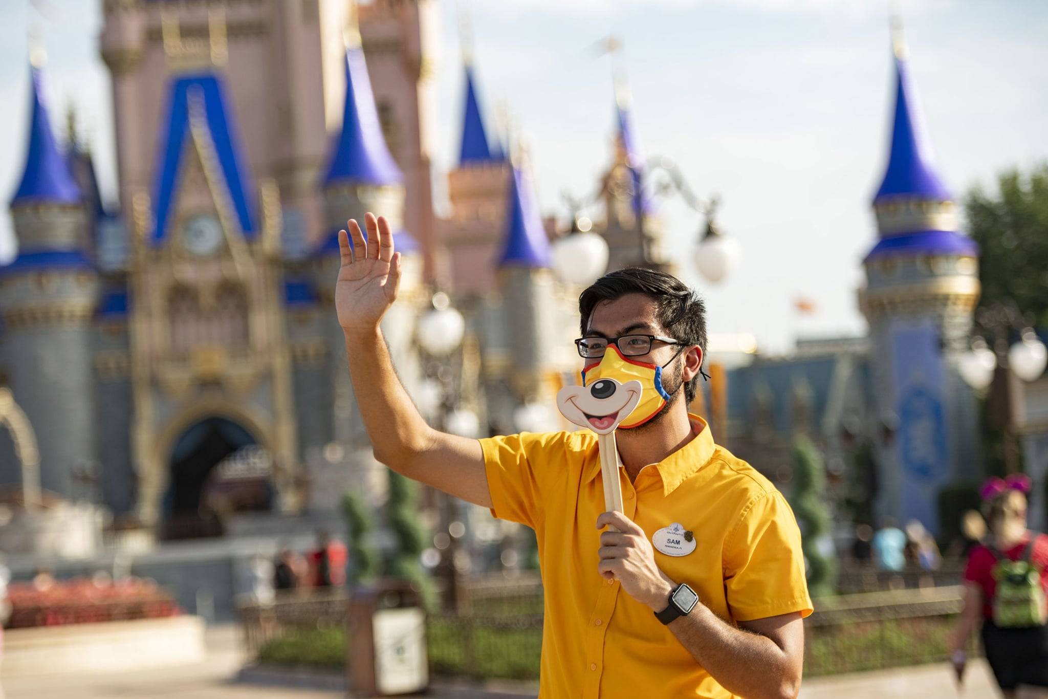 LAKE BUENA VISTA, FL - JULY 11:  In this handout photo provided by Walt Disney World Resort, a Disney cast member welcomes guests to Magic Kingdom Park at Walt Disney World Resort on July 11, 2020 in Lake Buena Vista, Florida. July 11, 2020 is the first day of the phased reopening. (Photo by Matt Stroshane/Walt Disney World Resort via Getty Images)