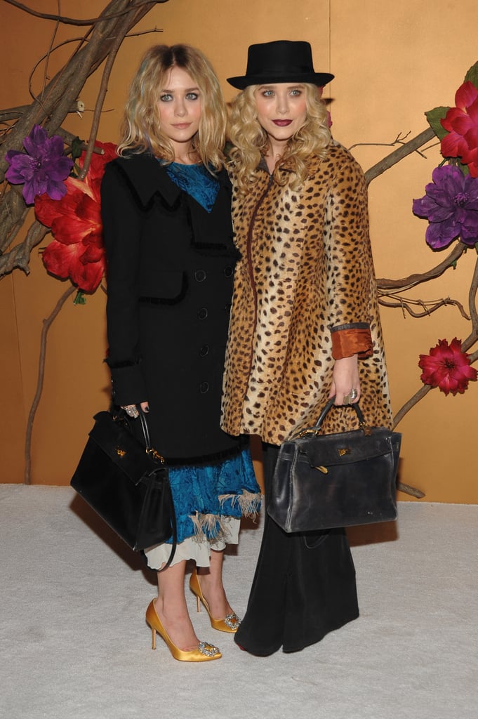 Twinning combo: The Olsens celebrated Tim Burton at a November 2009 MOMA film benefit with quirky couture styles and matching black leather satchels.

Ashley played up her faint blue streaks with a ruffled turquoise dress and mustard-colored satin pumps.
Mary-Kate channeled Tim Burton's quirky side with a leopard coat, wide-leg trousers, and a porkpie hat.