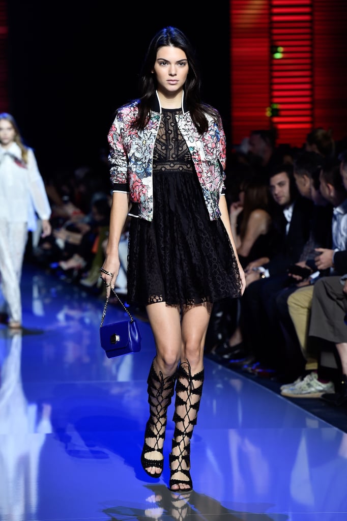 For her first walk down the Elie Saab runway, Kendall wore a black dress, floral bomber jacket, and lace-up sandals.