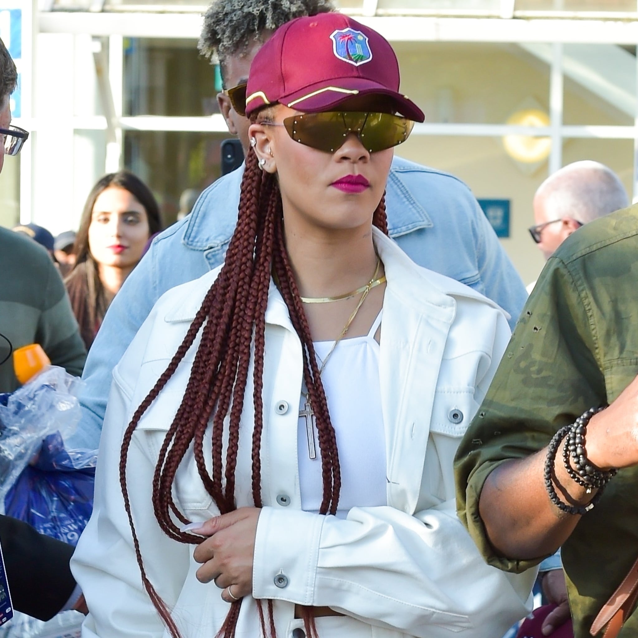 Rihanna Wearing a Baseball Cap and White Jeans