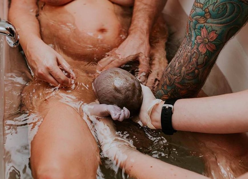 Every hand was there to help during this bathtub birth.