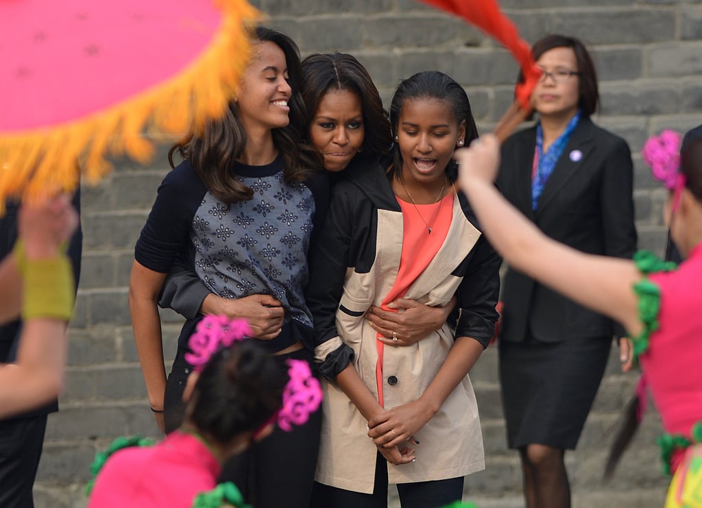 Michelle Obama hugged Malia and Sasha while they watched a traditional performance in Xi'an.