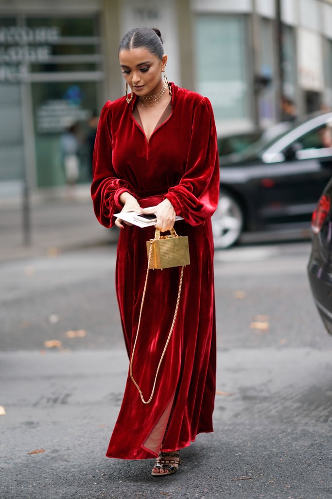 Invest in a long maxi dress that does all the work for you. If you do want to make your look feel festive, opting for velvet and accessorizing with gold jewelry will do the trick.