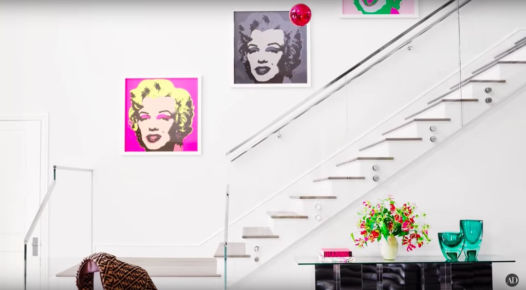 The pop art placed along the wall above Kylie's staircase offsets nicely with the blank white canvas surrounding it.