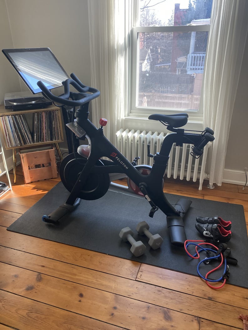 Home gym setup including stationary bike, jumprope, and weights.