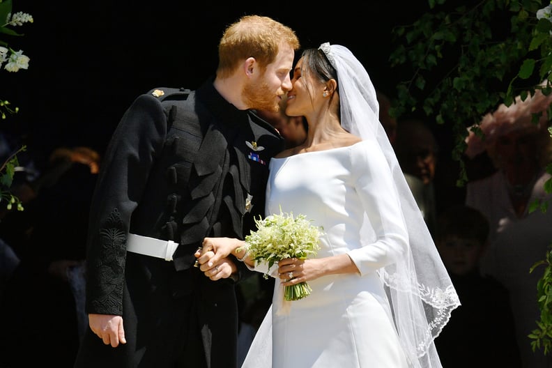 WINDSOR, UNITED KINGDOM - MAY 19:  Prince Harry and Meghan Markle kiss on the steps of St George's Chapel in Windsor Castle after their wedding in St George's Chapel at Windsor Castle on May 19, 2018 in Windsor, England. (Photo by Ben Birchall - WPA Pool/