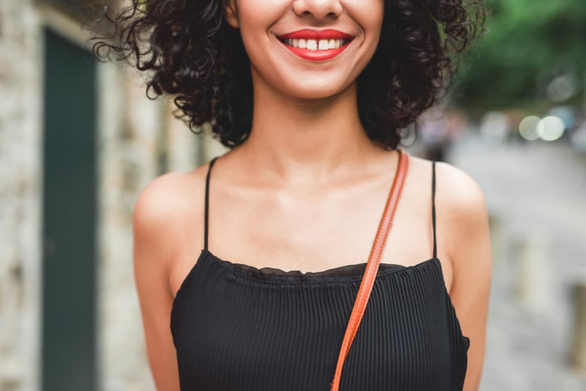 Cropped shot of a beautiful young woman smiling while standing outdoors
