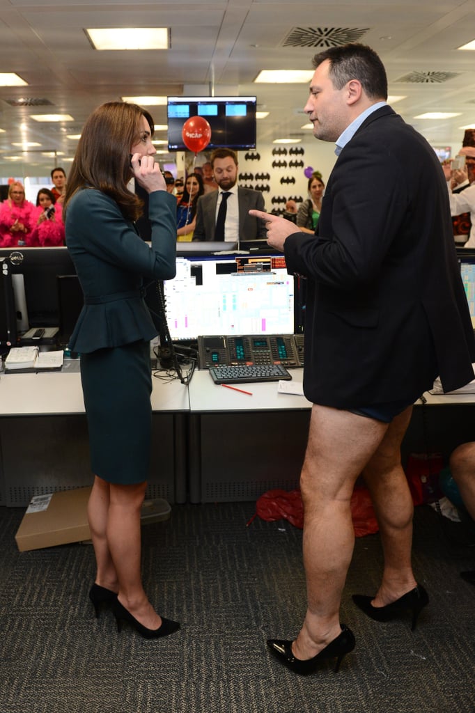 One thing's for sure — Kate was ready for anything that came her way in this ensemble. And let's be honest, next to this man in barely-there bottoms and heels, she proved that sometimes we should leave the sophisticated suit look to the duchess.