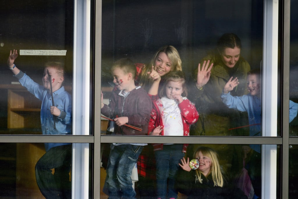 Friends and family stood near the window, waiting for the squadron's return.
