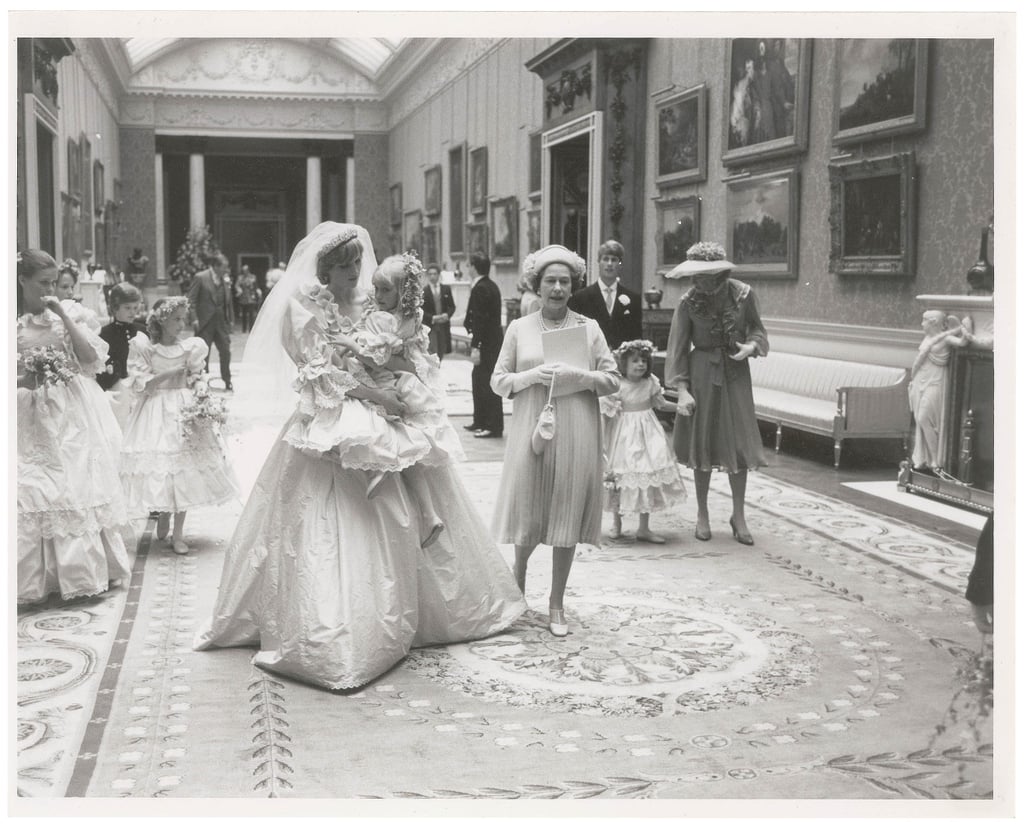 The wedding party walked through the halls of Buckingham Palace.