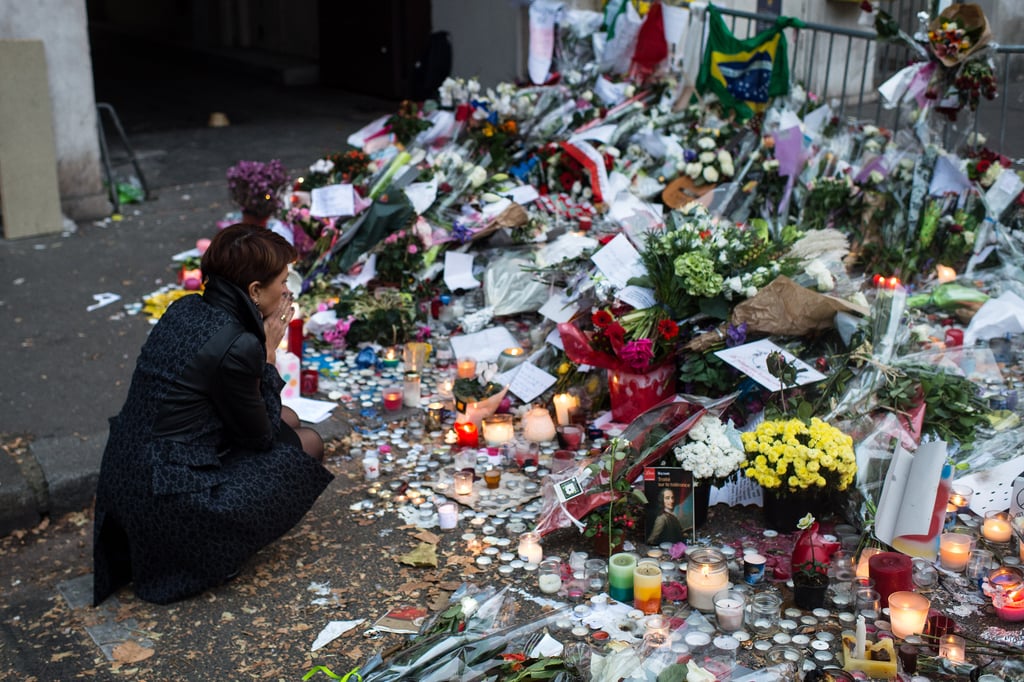 A woman sat in silence near the Bataclan Theater in Paris.