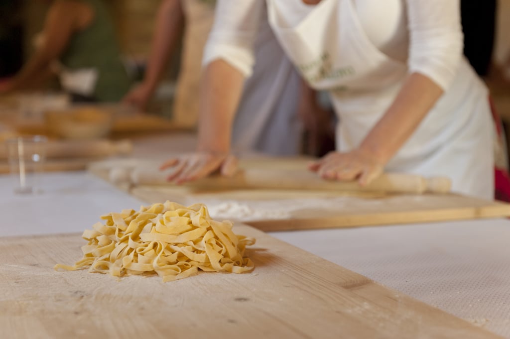 Unfold the strips, gently lay pasta in a pile, and sprinkle a touch of flour to prevent sticking.