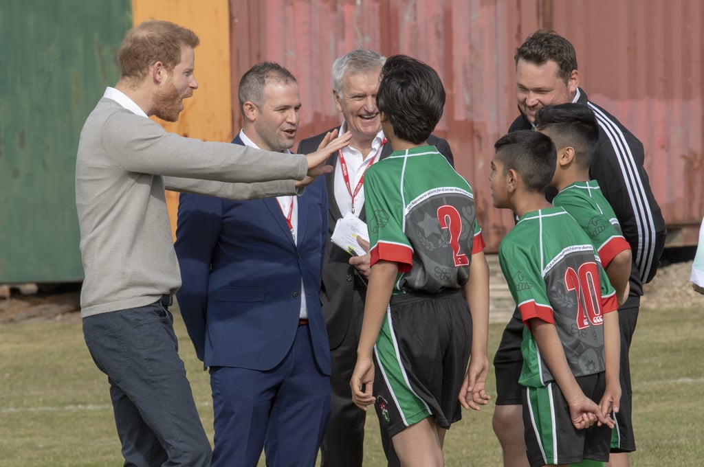 Prince Harry Hugs Kids at Lealands High School