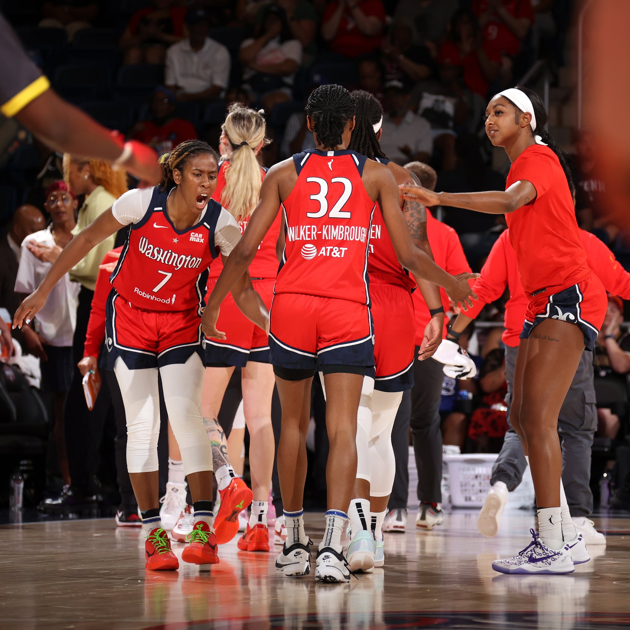 WASHINGTON, DC - JUNE 23: Ariel Atkins #7 and DiDi Richards #12 of the Washington Mystics high five Shatori Walker-Kimbrough #32 during the game against the Dallas Wings on June 23, 2024 at Capital One Arena in Washington, DC. NOTE TO USER: User expressly acknowledges and agrees that, by downloading and or using this Photograph, user is consenting to the terms and conditions of the Getty Images License Agreement. Mandatory Copyright Notice: Copyright 2024 NBAE (Photo by Stephen Gosling/NBAE via Getty Images)