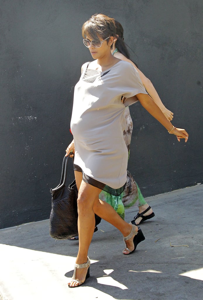 She did maternity style in T-strap sandal wedges and a completely coordinated outfit.