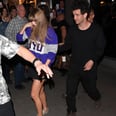 Taylor Swift Does Date Night in a Collegiate Sweatshirt and Pleated Miniskirt