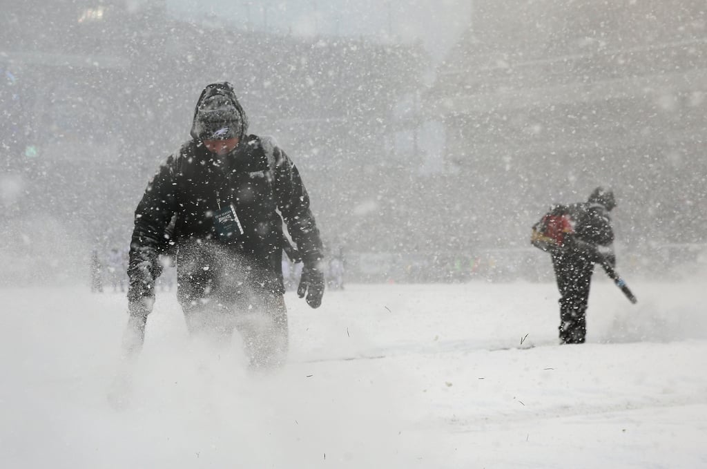 Stadium workers brought snowblowers onto the field to try to clear the lines during the game between the Philadelphia Eagles and the Detroit Lions in Pennsylvania.