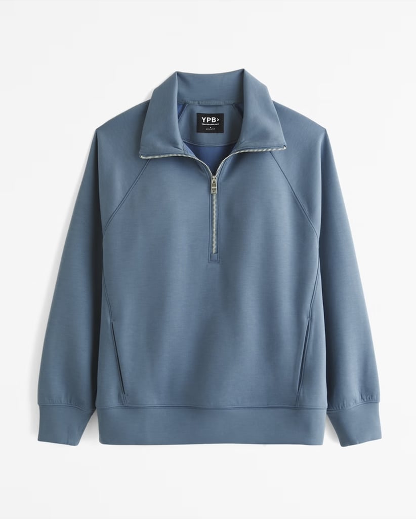 Active by Abercrombie YPB neoKNIT MAX Half-Zip, Blue ($53, originally $70)
Stay warm during the chilly months with this stylish Active by Abercrombie YPB half-zip, which is perfect for outdoor hikes, studio or gym workouts, and just lounging at home. The half-zip is designed with durability in mind, and the brand promises its sweat-wicking neoprene fabric it as soft as it is breathable, so you'll feel cozy without risking overheating. Plus, the mockneck collar and relaxed fit are so on trend. Read our Abercrombie & Fitch YPB Activewear review to learn more.
Editor Quote: "My favorite sets are those that come with a cute sweatshirt I can throw on to trek to and from the gym, or stop for a coffee afterward, and I can confirm the comfort and stretch of the NeoKnit Half-Zip, which honestly feels sort of official with its patent stitched onto the sleeve." — Sarah Wasilak, shopping director