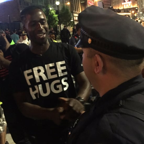 White Officer Hugs Black Man Offering Free Hugs
