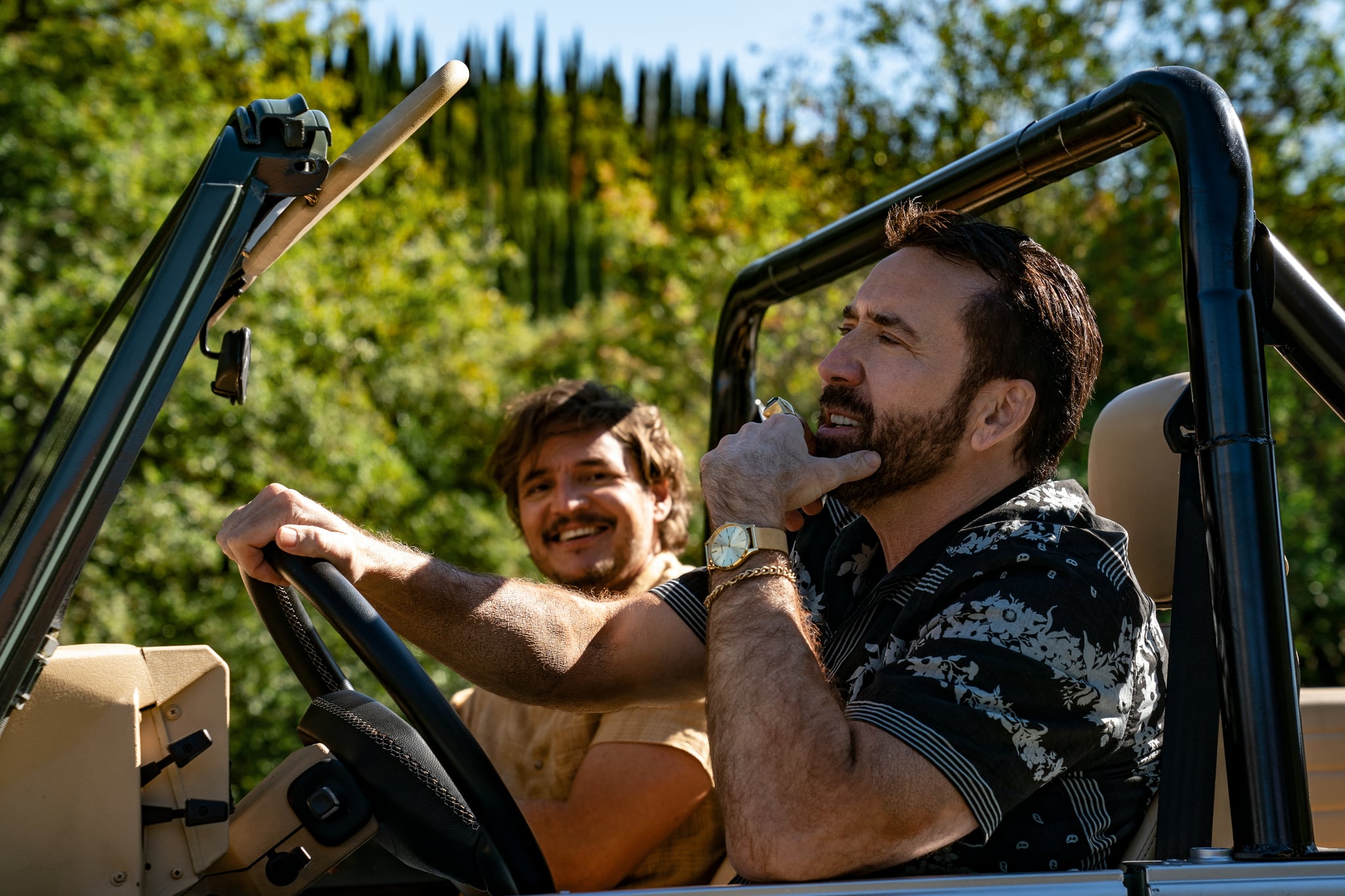 Javi Gutierrez' (Pedro Pascal, left) and 'Nicolas Cage' (Nicolas Cage, right) zooming through the mountains of Mallorca, Spain.  Photo Credit: Katalin Vermes/Lionsgate