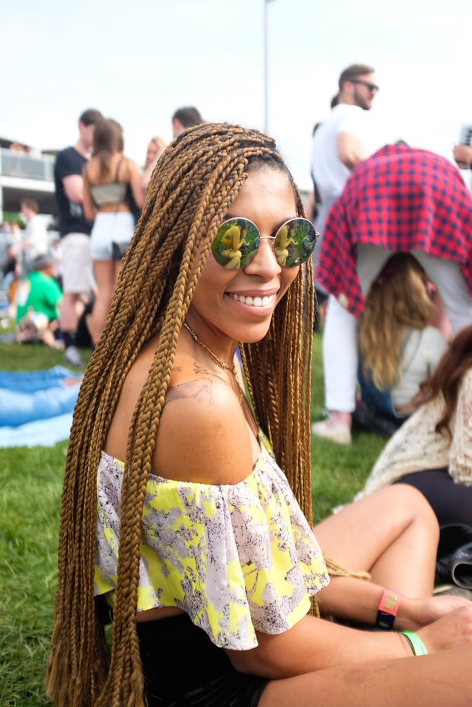We spotted round reflective sunglasses everywhere, but we love the way this style setter coordinated her sunglasses with her yellow off-the-shoulder top.