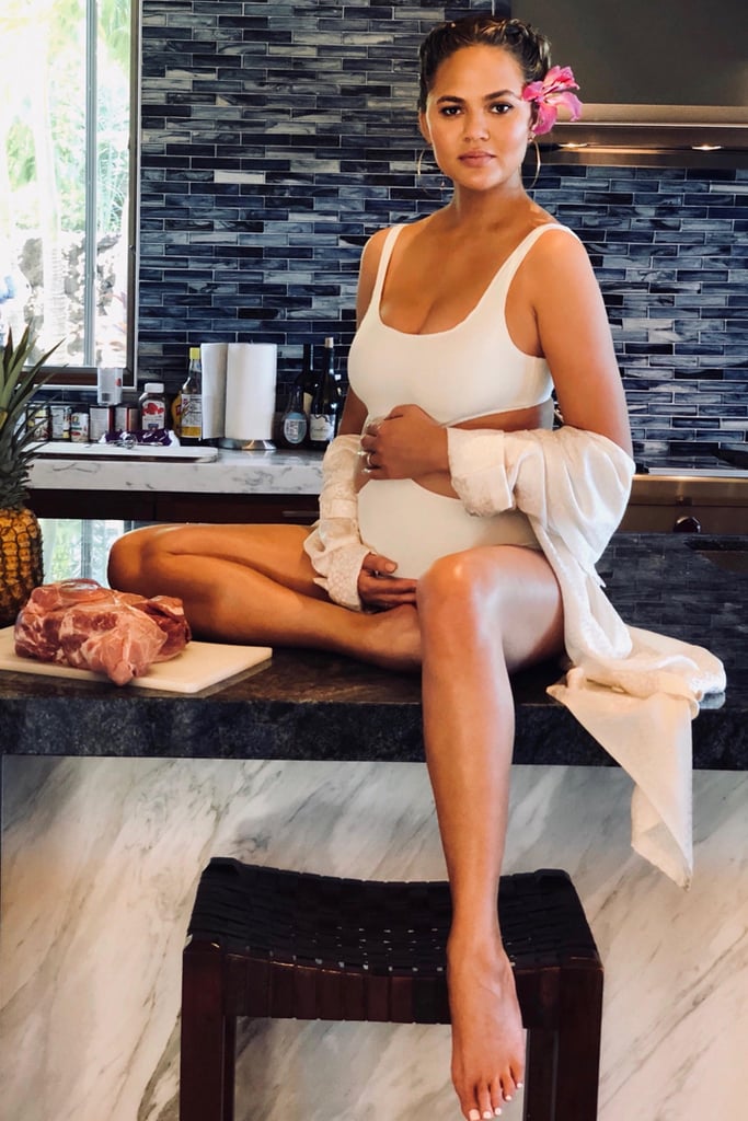 Chrissy wore a white cutout swimsuit by Solid & Striped for a kitchen photo shoot.