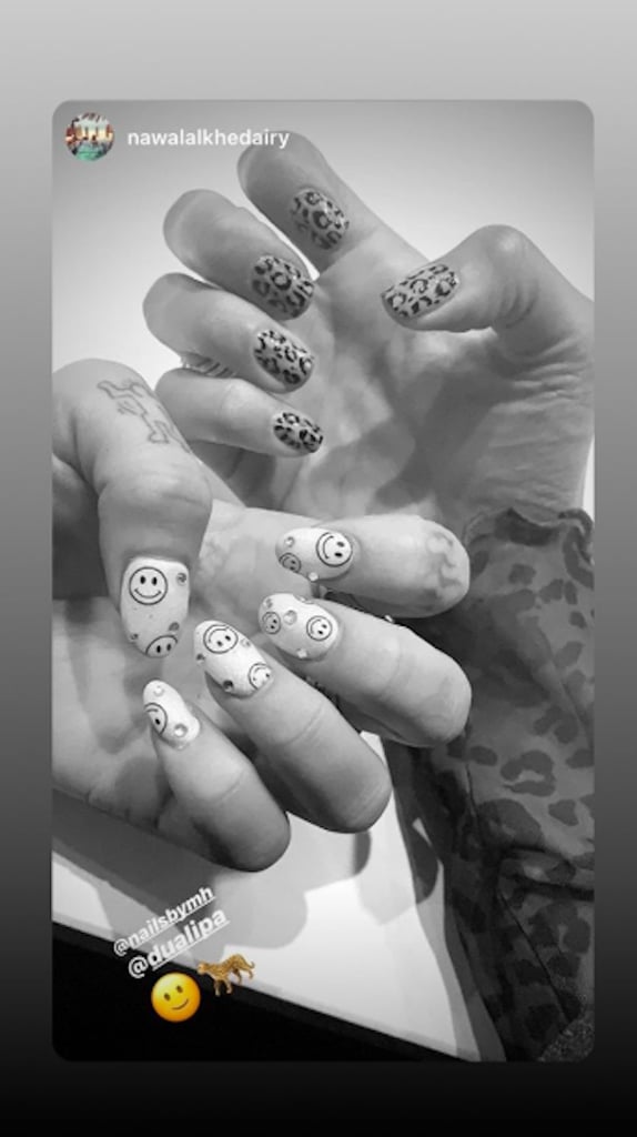 Dua Lipa has a lot to smile about, and she's letting everyone know with her latest manicure. The 24-year-old singer will be releasing her new single, "Don't Start Now," next week and announced it on Instagram right before showing fans her smiley face nail art. She credited her go-to artist Michelle Humphrey with the rhinestone-encrusted look, who let fans know that she used Gel Bottle Inc Nail Polish in Buttercup ($19) to create it.
This isn't the first time the star has worn a '90s-inspired motif on her nails. Back in June, Humphrey gave the singer tie-dye and smiley adorned nails that we couldn't stop staring at. 
Check out her latest smiley manicure, ahead.