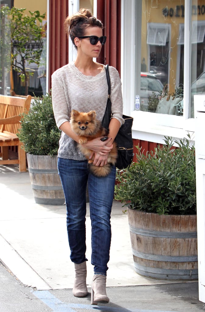 Jeans and ankle boots are staples of her weekend style. A thin sweater up top avoided extra bulk, and the pup was just plain cute.